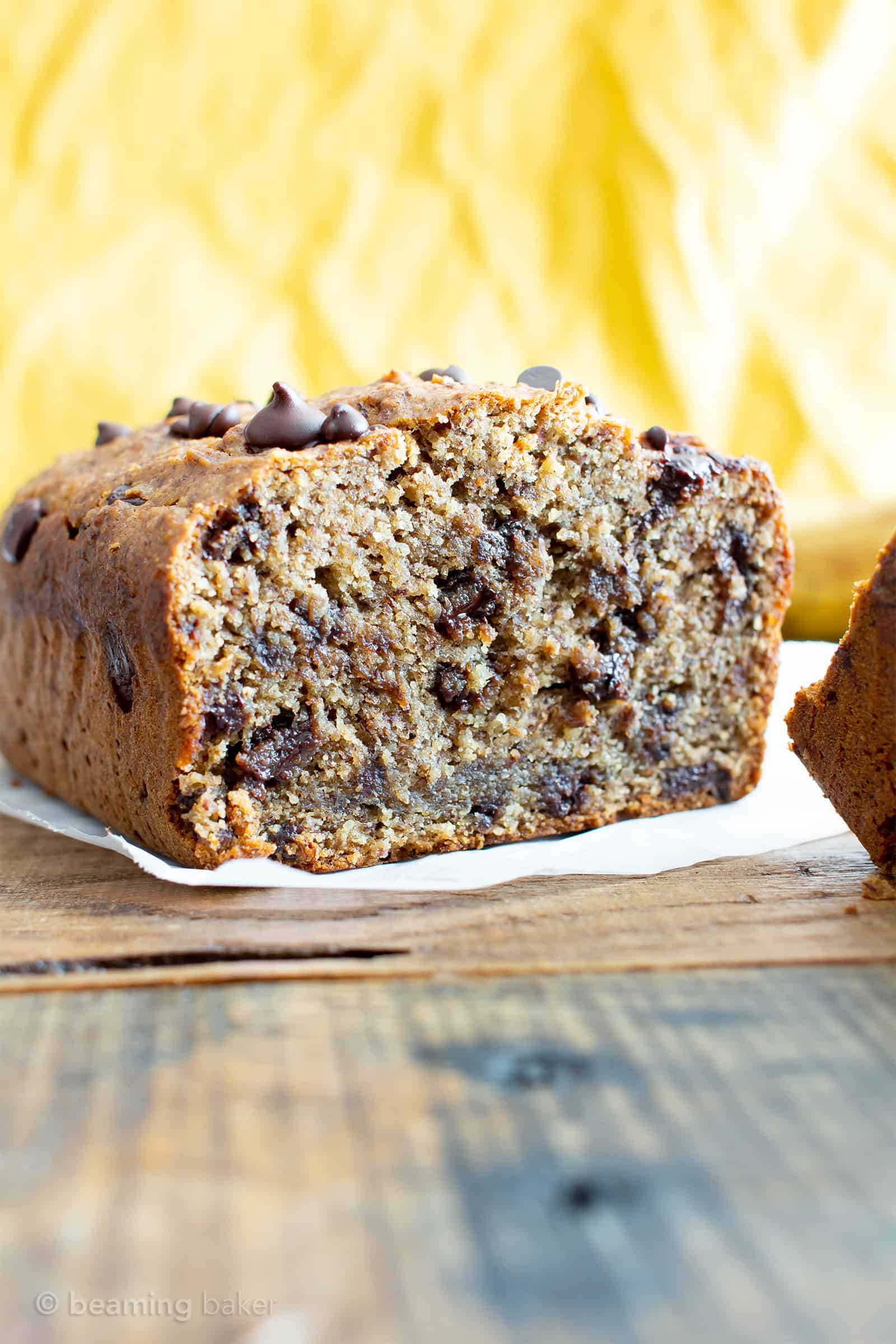 Best Moist Chocolate Chip Banana Bread Recipe (V, GF): a one bowl recipe for deliciously moist banana bread bursting with chocolate and made with healthy, whole ingredients. #Vegan #GlutenFree #DairyFree #Healthy #QuickBreads | Recipe at BeamingBaker.com
