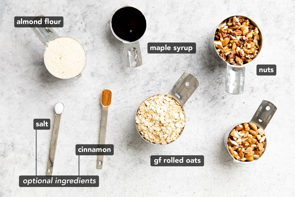 ingredients for gluten free granola like oats and nuts pre-measured in measuring cups and spoons