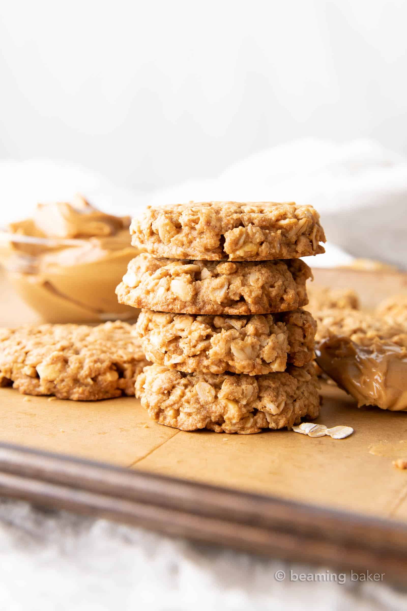 oat peanut butter cookies with healthy ingredients like peanut butter in a bowl on a prepared baking sheet